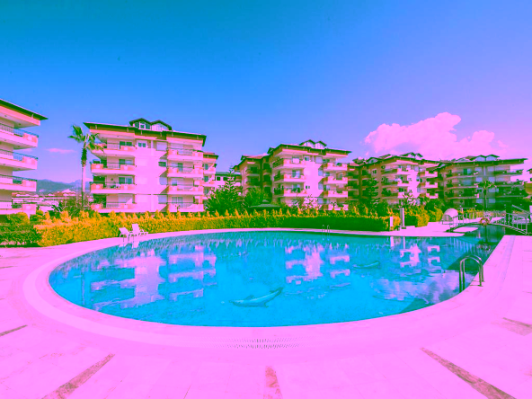 3-Zimmer-Wohnung kaufen in Alanya Oba in der Oba Oasis Anlage mit Pool, Garten und Stadtblick