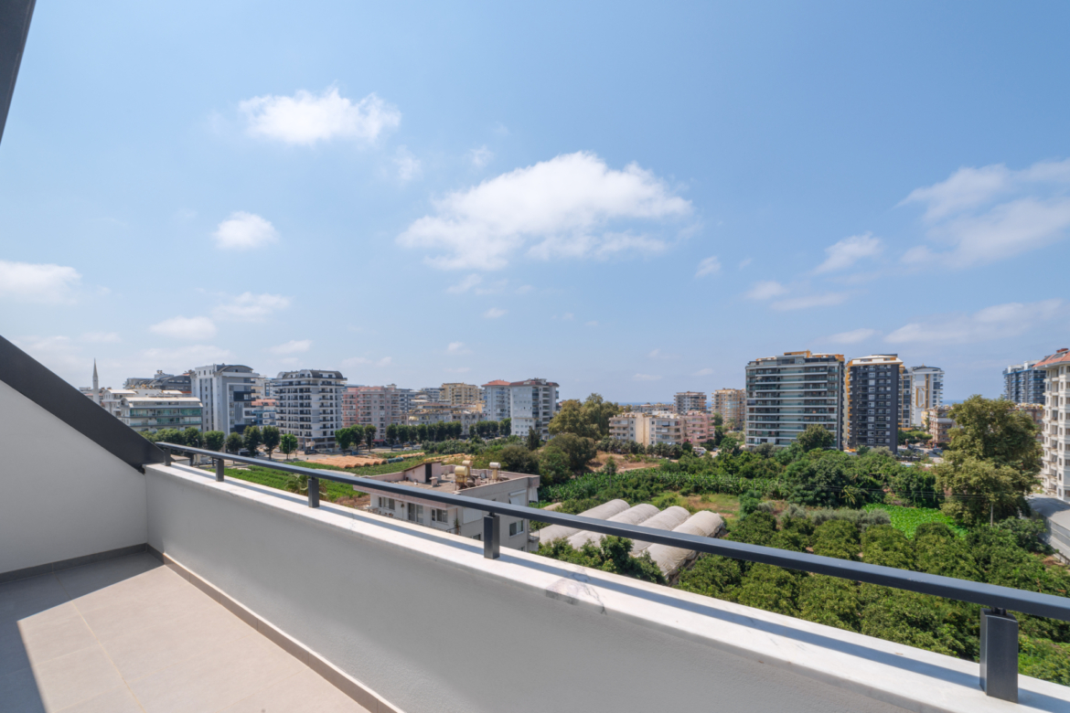 Panoramic view from the balcony of an apartment in Mahmutlar with city and partial sea views