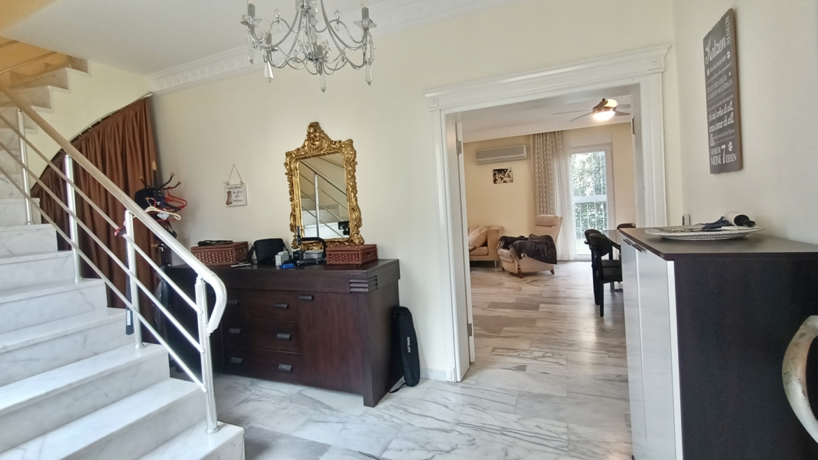 Eingangsbereich einer freistehenden Villa in Alanya mit Marmorboden, Treppe und Blick in den Wohnbereich