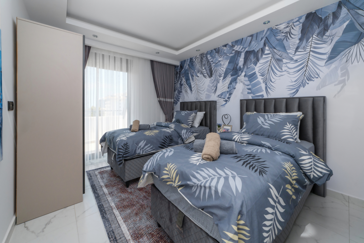 Children's room with two single beds in a modern apartment in Mahmutlar